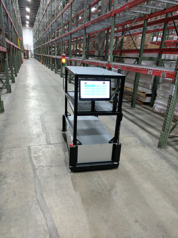 SB-Cart moving through a warehouse aisle
